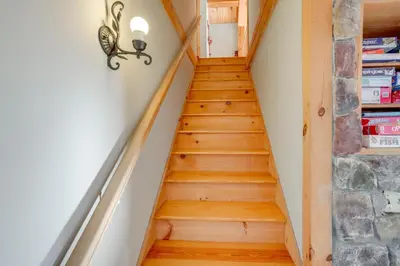 a staircase in a house with wooden floors at 1 Mi to Mt Snow Luna Stella Home with Fireplace in West Dover