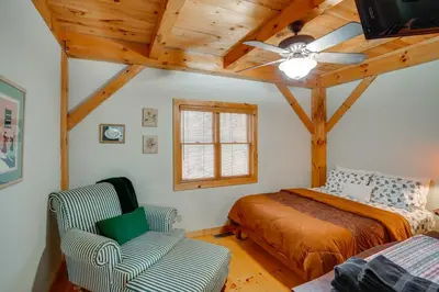 a bedroom with a bed and a chair in a room at 1 Mi to Mt Snow Luna Stella Home with Fireplace in West Dover