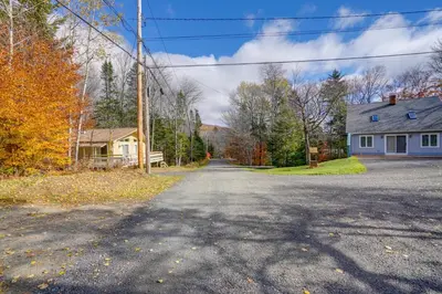 an empty road in a residential neighborhood with a house at 1 Mi to Mt Snow Luna Stella Home with Fireplace in West Dover