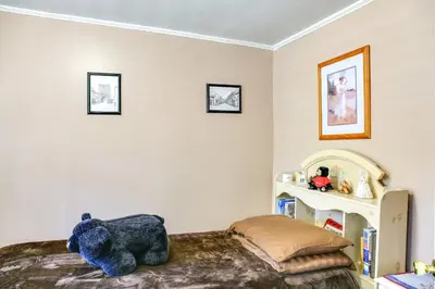 a bedroom with a teddy bear sitting on a bed at Hunter Home with Fire Pit and Yard On Main Street! in Hunter