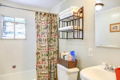 a bathroom with a toilet and a sink at Hunter Home with Fire Pit and Yard On Main Street! in Hunter