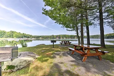 two picnic tables and a grill next to a lake at Peaceful Hamlin Home with Lake Access at The Hideout in Hamlin