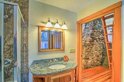 a bathroom with a sink and a mirror and a shower at Shelburne Studio Cabin with Spring-Fed Pool! in Shelburne