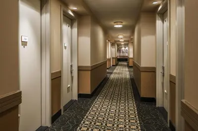 a corridor of a building with a long hallway at Opera House Hotel in Bronx