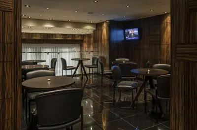 a restaurant with tables and chairs and a television at Opera House Hotel in Bronx