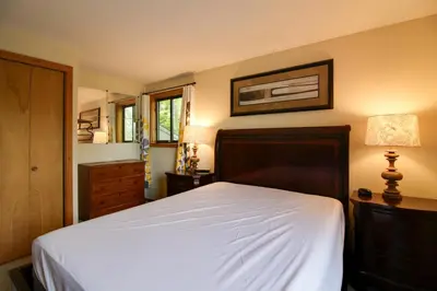 a bedroom with a bed and a dresser at Spacious Home Adjacent to Mt Snow with Game Room! in West Dover