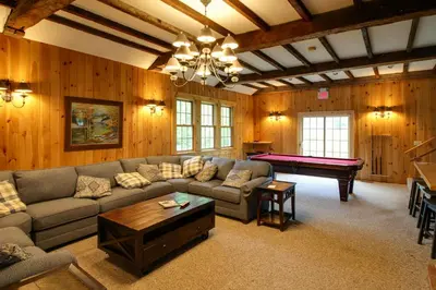 a living room with a couch and a pool table at Spacious Home Adjacent to Mt Snow with Game Room! in West Dover