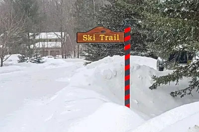 a street sign on a pole in the snow at Spacious Home Adjacent to Mt Snow with Game Room! in West Dover