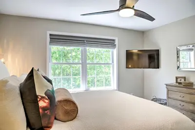 a bedroom with a bed with a ceiling fan and a window at Colonial-Style Warwick Retreat - 1 Hour to NYC! in Warwick