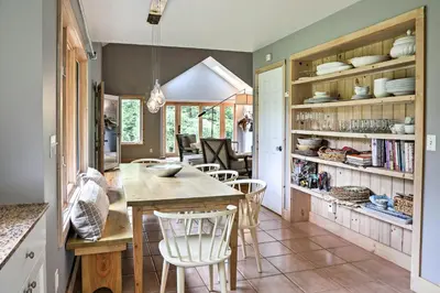 a kitchen with a table and chairs in a room at Berkshires Home on 11 Acres with Pond and 2 Fire Pits! in Becket