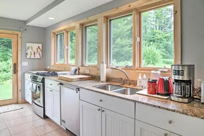 a kitchen with a sink and two windows at Berkshires Home on 11 Acres with Pond and 2 Fire Pits! in Becket
