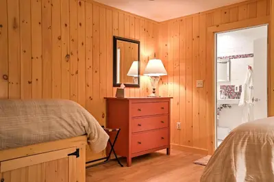 a bedroom with a bed and a dresser and a mirror at Berkshires Home on 11 Acres with Pond and 2 Fire Pits! in Becket