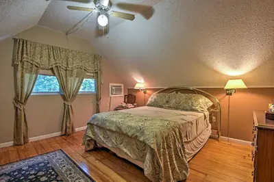 a bedroom with a bed and a ceiling fan at 1 Mi to Lake Wallenpaupack Pocono Mountain Home! in Greentown