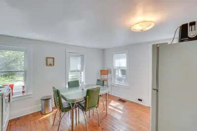 a dining room with a table and green chairs at UpdatedandPet-Friendly Cabin By Hikes and Woodstock! in Bearsville