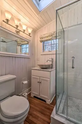 a bathroom with a toilet and a sink and a shower at Cozy Litchfield House with Fenced-In Yard and Fire Pit in Litchfield