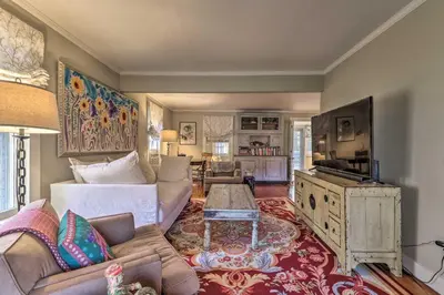 a living room with a couch and a table at Cozy Litchfield House with Fenced-In Yard and Fire Pit in Litchfield