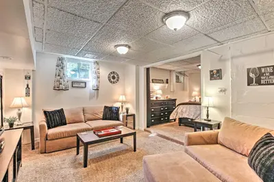 a living room with two couches and a bedroom at Cozy Agawam Studio with Yard 2 Miles to Six Flags! in Agawam