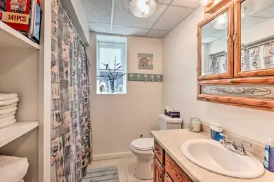 a bathroom with a toilet and a sink at Cozy Agawam Studio with Yard 2 Miles to Six Flags! in Agawam