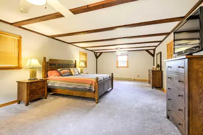 a bedroom with a bed and a dresser and a tv at Thompson Home with Deck and Pond, 8 Mi to Elk Mountain in Thompson