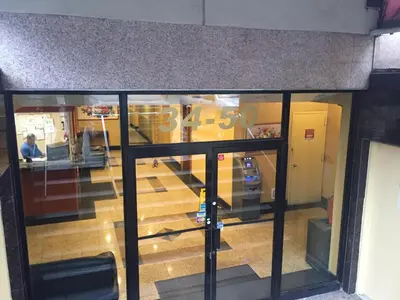a view through a glass door of a store at Flushing Motel in Queens
