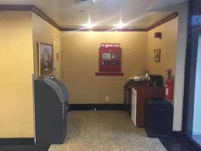 a room with two trash cans and a unintention at Flushing Motel in Queens