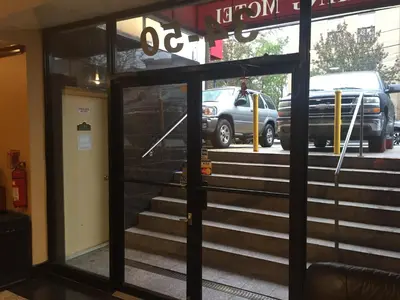 a view from the entrance of a building with stairs at Flushing Motel in Queens
