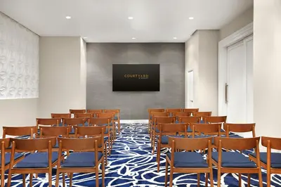 a room with a bunch of chairs and a flat screen tv at Courtyard by Marriott New York Manhattan/Chelsea in New York
