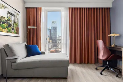 a living room with a couch and a window at Courtyard by Marriott New York Manhattan/Chelsea in New York