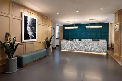 a lobby with a reception desk and a green wall at Residence Inn by Marriott New York Downtown Manhattan/World Trade Center Area in New York