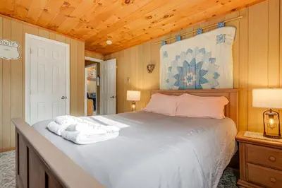 a bedroom with a bed with two towels on it at Near Hiking and Skiing Home in Wilmington! in Wilmington