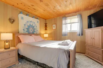 a bedroom with a bed and a television in it at Near Hiking and Skiing Home in Wilmington! in Wilmington