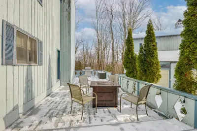 a patio with chairs and a table on a balcony at Near Hiking and Skiing Home in Wilmington! in Wilmington