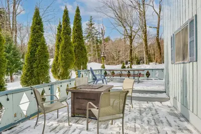a patio with chairs and a table in the snow at Near Hiking and Skiing Home in Wilmington! in Wilmington