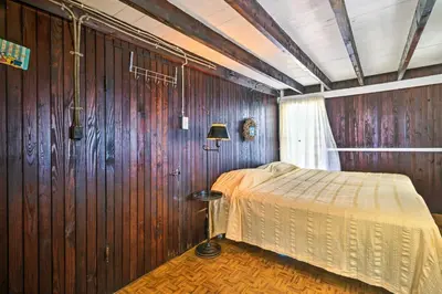 a bedroom with a bed in a wooden wall at Beachfront Connecticut Retreat with Views! in Milford