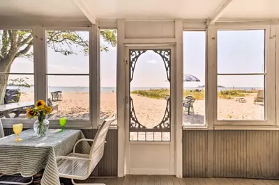 a dining room with a table and views of the beach at Beachfront Connecticut Retreat with Views! in Milford