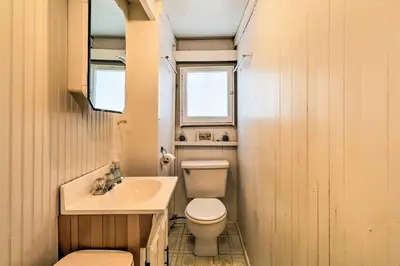 a small bathroom with a toilet and a sink at Beachfront Connecticut Retreat with Views! in Milford
