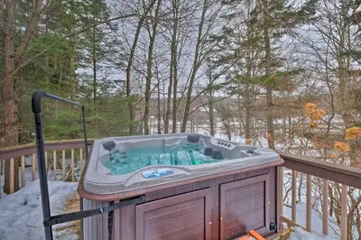 a hot tub on a deck in the snow at West Dover Vacation Rental with Hot Tub Near Mt Snow in West Dover
