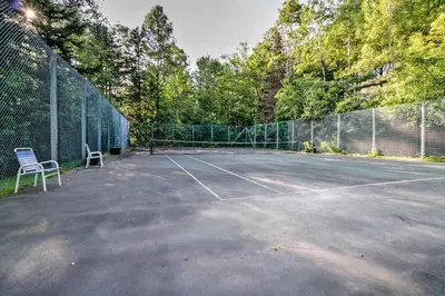 a tennis court with two chairs on it at West Dover Vacation Rental with Hot Tub Near Mt Snow in West Dover