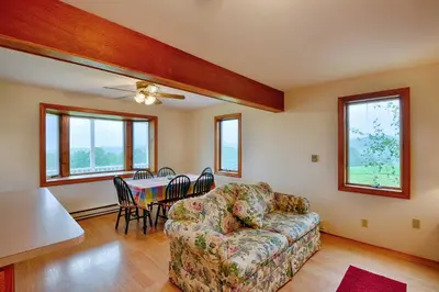 a living room with a couch and a table at Mountain Top Country Hideaway 48 Acres, Fire Pit! in Leonardsville