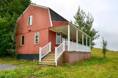 a red barn with a staircase in front of it at Mountain Top Country Hideaway 48 Acres, Fire Pit! in Leonardsville