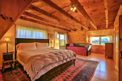 a bedroom with a large bed in a wooden room at Bearpen Lodge on 125 Acres - Near Belleayre Mtn! in Vega