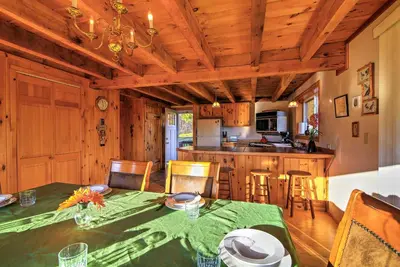 a dining room and kitchen with a table and chairs at Bearpen Lodge on 125 Acres - Near Belleayre Mtn! in Vega