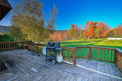 a grill on the deck of a house at Bearpen Lodge on 125 Acres - Near Belleayre Mtn! in Vega