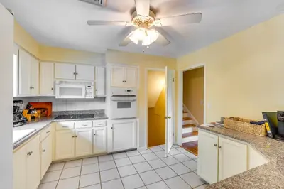 a kitchen with white cabinets and a ceiling fan at Hudson Valley Horse Farm Retreat in Salt Point in Salt Point