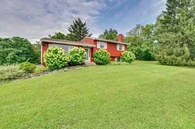 a red house with a large yard at Hudson Valley Horse Farm Retreat in Salt Point in Salt Point