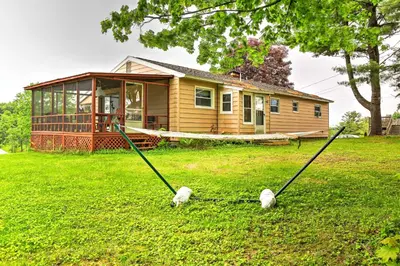 a house with two sheep on the yard at Mayfield Home with Private Dock on Lake Sacandaga! in Broadalbin