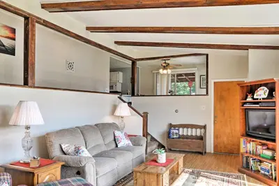 a living room with a couch and a tv at Mayfield Home with Private Dock on Lake Sacandaga! in Broadalbin