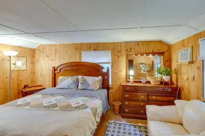 a bedroom with a bed and a dresser and a couch at Rustic Berkshires Cottage at Lake Buel with Kayaks! in New Marlborough