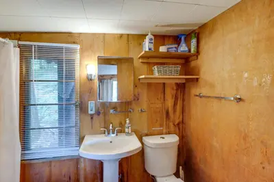 a bathroom with a toilet and a sink at Rustic Berkshires Cottage at Lake Buel with Kayaks! in New Marlborough