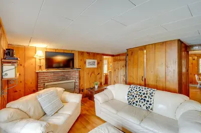 a living room with a couch and a fireplace at Rustic Berkshires Cottage at Lake Buel with Kayaks! in New Marlborough